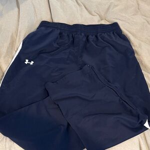 Blue and white Under Armour 3XL wind pants.  Black with white stripes down leg